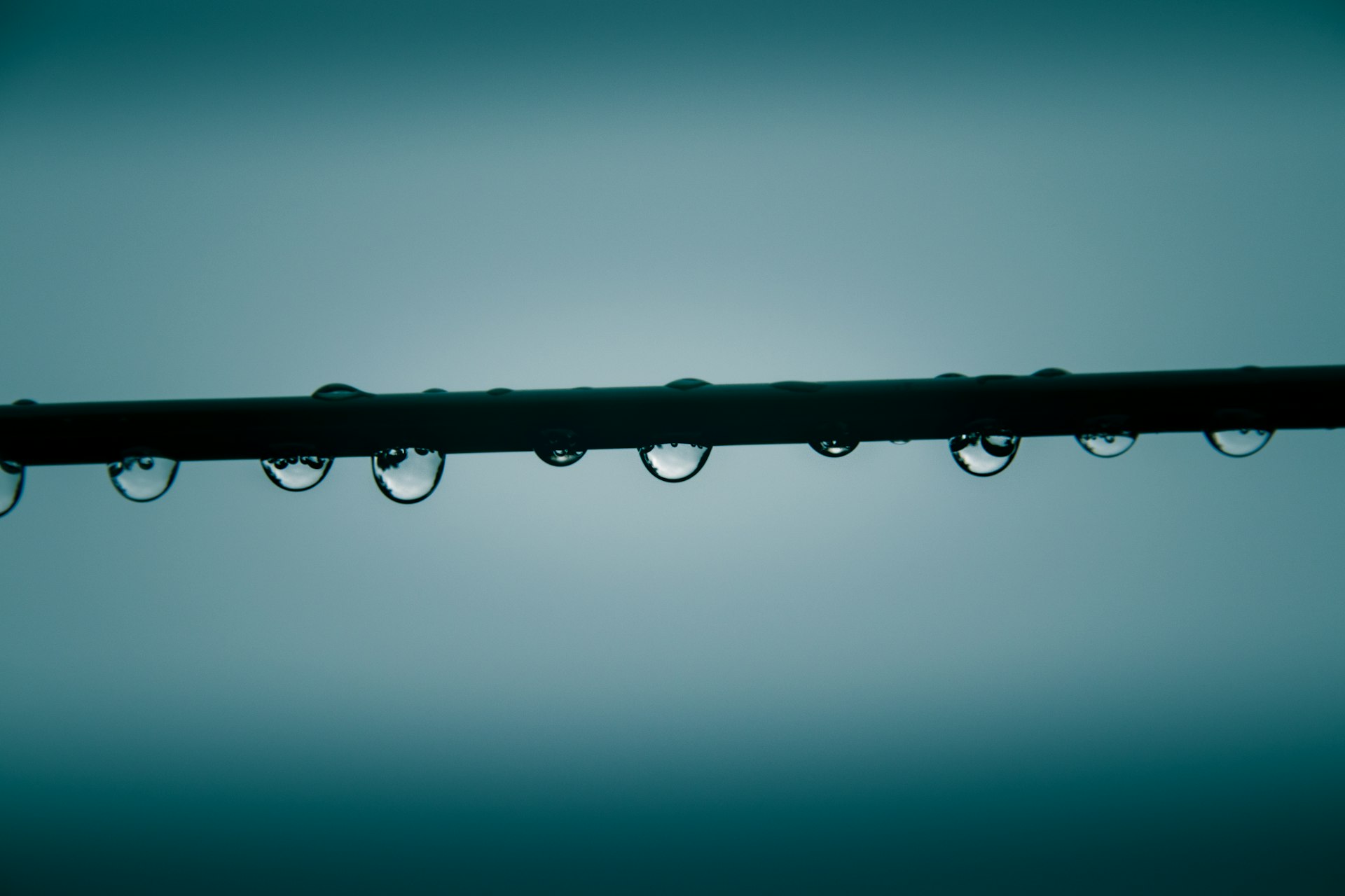 water droplets on black metal bar